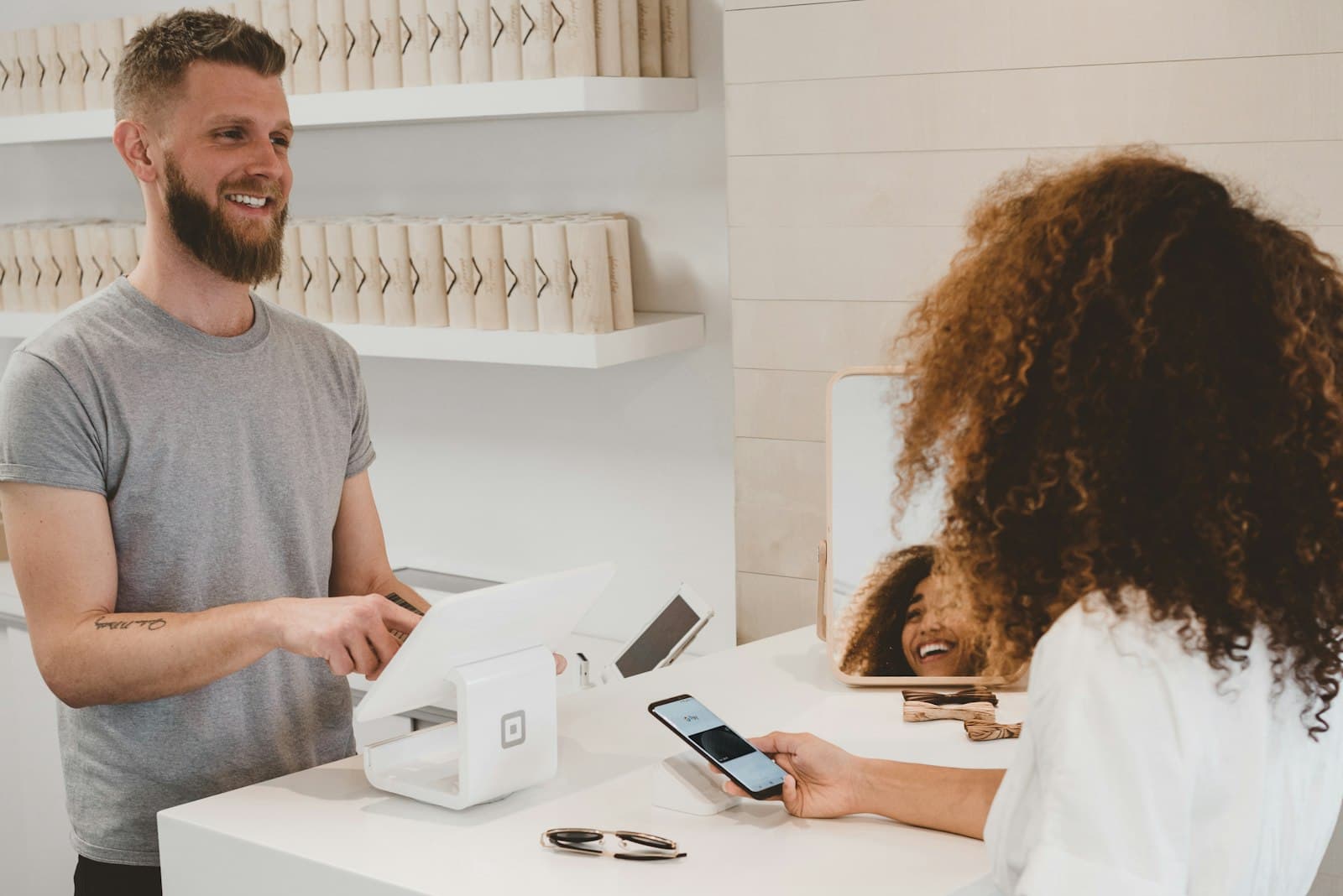 Customer paying at a modern retail checkout with a card terminal
